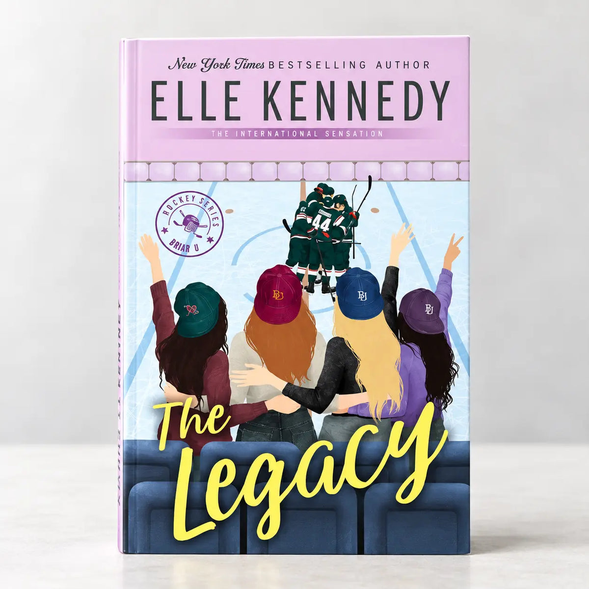 The Legacy by Elle Kennedy hardcover book front cover featuring hockey players and cheering fans