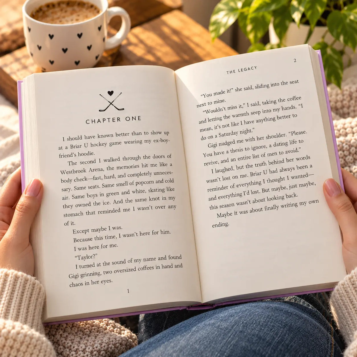 The Legacy by Elle Kennedy open hardcover book showing interior pages in a cozy reading setting